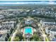 Aerial view showcasing a large community pool and beautiful building surrounded by lush greenery and homes at 2240 Osprey Ave, Orlando, FL 32814