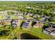 Aerial view of the property with solar panels, including the pool, bordered by a red outline, lush surroundings at 2569 Gabrielle Woods Pl, Oviedo, FL 32765