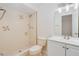 Bathroom featuring a walk-in shower with neutral tile and updated vanity with double sinks at 2921 Sabal Palm Dr, Edgewater, FL 32141