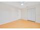 Spacious bedroom featuring a large closet, neutral walls, and modern wood-look tile flooring at 2921 Sabal Palm Dr, Edgewater, FL 32141