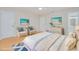 Bright staged bedroom with beach themed décor, ceiling fan, and light, neutral flooring at 2921 Sabal Palm Dr, Edgewater, FL 32141