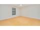 A naturally lit bedroom includes a ceiling fan and unique wood-look tile flooring at 2921 Sabal Palm Dr, Edgewater, FL 32141