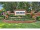 Community entrance to DeBary Golf & Country Club with brick walls and a landscaped flower bed at 333 La Creek Ct, Debary, FL 32713