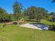 Community with a playground and basketball court surrounded by trees in a grassy area under a clear, sunny sky at 333 La Creek Ct, Debary, FL 32713