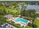 Aerial view of a community pool with lounge chairs, tables, and a clubhouse in a residential neighborhood at 333 La Creek Ct, Debary, FL 32713