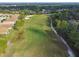 Aerial shot of a verdant golf course fairway winding through a residential area with mature trees at 333 La Creek Ct, Debary, FL 32713