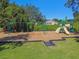Community playground featuring swings, slides, and climbing structures for children in a grassy area under a clear, sunny sky at 333 La Creek Ct, Debary, FL 32713