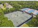 Overhead view of multiple tennis courts surrounded by lush greenery in a residential community at 333 La Creek Ct, Debary, FL 32713