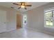 Neutral bedroom with tile flooring, ceiling fan, closet, and multiple bright windows at 6506 Swissco Dr # 1317, Orlando, FL 32822