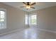 Neutral bedroom with tile flooring, ceiling fan, and two bright windows at 6506 Swissco Dr # 1317, Orlando, FL 32822