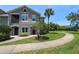 Inviting townhouse with a sidewalk, landscaping, and a playground nearby at 6506 Swissco Dr # 1317, Orlando, FL 32822