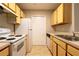 Efficient kitchen layout featuring essential appliances and ample cabinet space at 6506 Swissco Dr # 1317, Orlando, FL 32822