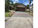Exterior shot showcasing the new concrete driveway leading up to the home's facade and garage at 705 Boysenberry Ct, Winter Springs, FL 32708