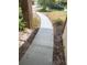 Image featuring a new concrete walkway leading through the landscaped front yard of the home at 705 Boysenberry Ct, Winter Springs, FL 32708