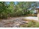 Lush backyard featuring a concrete patio, mature trees, and privacy landscaping at 100 Des Pinar Ln, Longwood, FL 32750