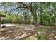 Exterior backyard with grass and mature trees at 100 Des Pinar Ln, Longwood, FL 32750