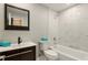 Modern bathroom with tiled tub, dark wood vanity, and stylish fixtures at 100 Des Pinar Ln, Longwood, FL 32750