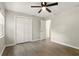 Bedroom featuring a ceiling fan, double door closet and wood-look flooring at 100 Des Pinar Ln, Longwood, FL 32750