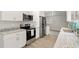 Modern kitchen featuring stainless steel appliances, granite countertops, and white cabinets at 100 Des Pinar Ln, Longwood, FL 32750
