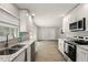 Modern kitchen with stainless appliances, granite countertops, and bright natural light overlooking living area at 100 Des Pinar Ln, Longwood, FL 32750