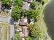 Aerial view of a property with a pool, landscaping, and a lake view at 1017 American Beauty St, Orlando, FL 32818