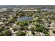 High-angle view of a neighborhood with a lake surrounded by tree-lined streets and single-Gathering homes at 1017 American Beauty St, Orlando, FL 32818