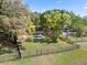 Backyard view featuring inviting pool, screened porch, and mature landscaping at 1017 American Beauty St, Orlando, FL 32818