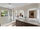 Modern bathroom with double vanity, granite countertop, and a glass-enclosed shower at 1017 American Beauty St, Orlando, FL 32818