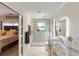 Contemporary bathroom with a glass shower, granite vanity, and access to the main bedroom at 1017 American Beauty St, Orlando, FL 32818