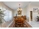 Elegant dining room with a large wooden table, chandelier, and ample natural light at 1017 American Beauty St, Orlando, FL 32818