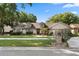 Charming single-story home with well-manicured lawn and mature trees in a quiet residential neighborhood at 1017 American Beauty St, Orlando, FL 32818
