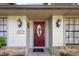 Elegant front entrance with a red door, decorative sidelights, stylish lighting fixtures and charming details at 1017 American Beauty St, Orlando, FL 32818