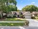Charming single-Gathering home featuring a well-manicured lawn, mature trees, and a two-car garage at 1017 American Beauty St, Orlando, FL 32818