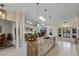 Open-concept kitchen with island, granite countertops, and stainless steel appliances flowing into living area at 1017 American Beauty St, Orlando, FL 32818