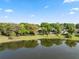 Scenic lake view featuring lush greenery, a serene waterfront, and glimpses of lakeside homes at 1017 American Beauty St, Orlando, FL 32818