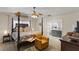 Comfortable main bedroom featuring a four-poster bed, chair, and en-suite bathroom at 1017 American Beauty St, Orlando, FL 32818