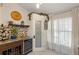 Butler's pantry with wine fridge, custom cabinets, decorative tile, and frosted glass door at 1017 American Beauty St, Orlando, FL 32818