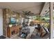 Beautiful covered patio with stone accents, outdoor kitchen, and comfortable seating at 1017 American Beauty St, Orlando, FL 32818
