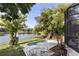 A sparkling pool overlooks a serene lake surrounded by lush greenery and mature trees at 1017 American Beauty St, Orlando, FL 32818