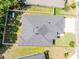 Aerial view of home showcasing the roof and surrounding yard, with a red property outline at 113 St Thomas Dr, Mulberry, FL 33860