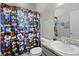Well-lit bathroom featuring a Mickey Mouse shower curtain and a sink at 113 St Thomas Dr, Mulberry, FL 33860