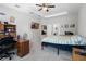 Comfortable bedroom featuring a ceiling fan, a TV, and access to an en-suite bathroom at 113 St Thomas Dr, Mulberry, FL 33860