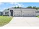 Attractive gray stucco home with a pristine lawn and a two-car garage at 113 St Thomas Dr, Mulberry, FL 33860
