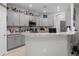 Well-lit kitchen featuring gray cabinets, stainless steel appliances, and ample counter space for cooking and entertaining at 113 St Thomas Dr, Mulberry, FL 33860