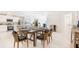 A dining area with a kitchen, island seating, and table set for a meal at 114 Tulip Ln, Poinciana, FL 34759