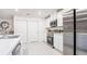 Bright kitchen featuring white cabinets, stainless steel appliances, and a functional island at 114 Tulip Ln, Poinciana, FL 34759