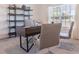 Modern home office with stylish desk, shelving, and bright natural light from a large window at 114 Tulip Ln, Poinciana, FL 34759