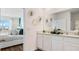 Stylish bathroom featuring double sinks, modern fixtures, and decorative accents, blending functionality with elegance at 1218 Alstonia Ln, Mount Dora, FL 32757