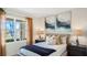 Inviting bedroom features a large window, soft lighting, and stylish decor, offering a relaxing retreat at 1218 Alstonia Ln, Mount Dora, FL 32757