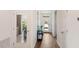 Inviting foyer with a view into the kitchen and a mirrored door, offering a bright and open entrance at 1218 Alstonia Ln, Mount Dora, FL 32757